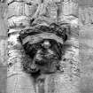 Detail showing corbel carved with an angel holding an arma Christi emblem; South front, South range