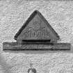 Pediment in W wing-wall of house; dated 1661 and faces S