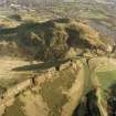 Oblique aerial view of Holyrood Park centred on the remains of quarries on Salisbury Crags with Arthur's Seat behind, taken from the WSW.