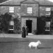 Ardbeg House
View of three people and white dog outside Ardbeg House (House of Colin Hay of Ardbeg)