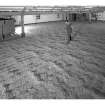 Bowmore Distillery, Bowmore, Islay.
View of Malting floor, ploughing barley in course of germination.