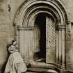 View of lady outside the North cloister doorway at Melrose Abbey.