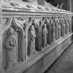 Cullen church. Detail of robed figures along base of medieval tomb.