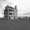 Fearn Airfield Naval Control Tower, view from S showing rear elevation of tower and Nissen hut to the rear.
