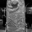 Glasgow, Govan Old Parish Church, interior
General view of rear of No.8 upright cross-slab, 'The Sun Stone', swirl of fat serpents emerging from sun symbol with interlace panel below.