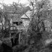 Millmannoch, Mill
View of sluice gate under road, mill in background, from S
