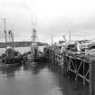 Islay, Port Ellen, Pier
View from NNE showing fishing boats docked on E front of wood and iron steamer pier extension