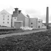 Islay, Lagavulin Distillery
View from WSW showing WSW front of malt barns and kilns with chimney in background