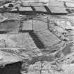 Balquhatstone Colliery and Drumclair, oblique aerial view, taken from the SSE, showing coal mines, coke ovens and miners' rows at Balquhatstone linked by a mineral railway, and enclosing an area of rig, in the centre of the photograph, and the faint remains of Drumclair miners' rows in the bottom.