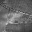 Green of Invermay, oblique aerial view, taken from the SW, centred on the cropmarks of a palisaded enclosure, ring-ditch and pits. Further pits and a ring-ditch are visible in the top half of the photograph.