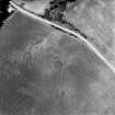 Pityoulish, oblique aerial view, taken from the ESE, centred on the cropmarks of a round house, pits and a possible souterrain.