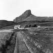 Distant view of the Old Inn, with the Sgurr of Eigg behind, (postcard) inscr; 'The Sguir.'