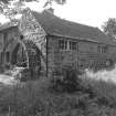 Millmain, Mill
View from ENE showing NNE front and waterwheel on SE front