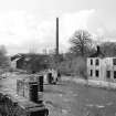 View of bridge over River Kelvin, Glasgow from NE showing piers of bridge and ENE front of ruins of cottages with Kelvindale Paper Mill in distance. Built c. 1896 for the Lanarkshire and Dumbartonshire Railway.