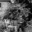View of man and woman sitting in garden at Hillside, 44 The Causeway, Edinburgh.