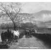 Postcard view from N of men and horses returning to village with Pentland Hills in background