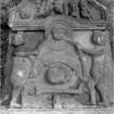 View of gravestone 'Iain Laidlaw d.1739' (Laidlaw). Showing two naked putti holding a swag with a central winged head over a 'MEMENTO MORI' ribbon, skull, bone and hourglass. Tympanum shows a skull, hourglass and three figures holding a mallet, scythe and skull (?)