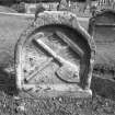 View from W of gravestone commemorating W B and M G d.1657; rake and shovel crossed.