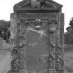 Stenton churchyard.
Inscription illegible. East face; portrait of gentleman holding skull in pediment. Inscription panel bordered by various emblems of death and mortality.