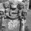 View of headstone of Robert Wilson d.1741. Reverse face; crown and hammer, flanked by symbols of mortality and cherubs.