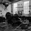 Huntingtowerfield, Bleach and Dye Works, Interior
View of mechanics shop showing remains of W. Robertson and Company Johnstone Lathe, chuck 70 centimetres diameter.