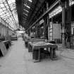 Paisley, MacDowall Street, Caledonia Engineering Works, Interior
View looking S in E bay of boiler shop showing several massive box tables and on right, between crane truck supports, there is a shop air heater