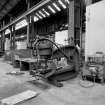 Paisley, MacDowall Street, Caledonia Engineering Works, Interior
View of boiler shop looking SW showing hydraulic riveting machine which has been converted to a plate bender (gap between legs of frame 40cm x 110cm from ram to back of frame) with shop air heater and hydraulic unit to right