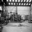 Paisley, MacDowall Street, Caledonia Engineering Works, Interior
View of boiler shop looking S showing punching and shearing machine complete with lifting jib (made by G Edward and Company Engineers, Johnstone) with door to latrines on right