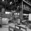 Paisley, MacDowall Street, Caledonia Engineering Works, Interior
View of boiler shop looking NW showing welding machine made by Macobe, Essex with rotating horizontal table (top of hydraulic accumulator in background)