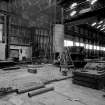 Paisley, MacDowall Street, Caledonia Engineering Works, Interior
View of boiler shop looking NW showing furnace plates and box table to right and hydraulic accumulator in background with 2 overhead cranes above (5 ton crane on left and 15 ton crane on right)