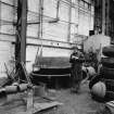 Paisley, MacDowall Street, Caledonia Engineering Works, Interior
View of boiler shop looking NW showing various dies for forming end flanges for boilers and company  with shop air heater and G. J. Douglas in background