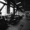 Paisley, MacDowall Street, Caledonia Engineering Works, Interior
View looking E on N side in machine shop showing long bed centre lathe which is made by Dean, Smith and Grace