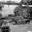 Coatbridge Engine Works, Engineering Shop; Interior
View looking NE at Richards No.215 planer (table 6m long, 3m wide; maximum work piece 3.6m wide and 2.6m high. To the right of the planer is Butler No. 312 slotter (.76m) strake. On the foreground on the table is the 'press arm' of a brick press under repair.