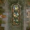 Interior. North chapel, stained glass window on north wall showing scenes from the life of Christ.