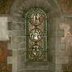 Interior. North chapel, stained glass window on north wall showing scenes from the lives of the Saints.