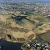 Oblique aerial view of Holyrood Park centred on the remains of cultivation terraces, taken from the SE.