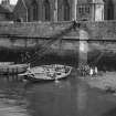 Newhaven Harbour.
View of children playing in fishing boats by harbour wall in front of Newhaven Free Church, Pier Place, at low tide.