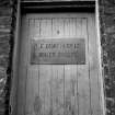 Paisley, MacDowall Street, Caledonia Engineering Works
View showing plaque on door which is inscribed 'A.F. CRAIG & CO. LTD. BOILER MAKERS'