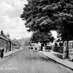 Edinburgh, Gilmerton, Drum Street.
View of the main street with three ladies.
Insc: 'Main Street, Gilmerton' '2083'.