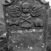 Gravestone commemorating Ann Williamson, d.1780. Winged cherub; winged hourglass, crossbones, coffin, skull in profile.