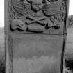 Gravestone commemorating Elizabeth McKittrick, d.1751. Winged cherub; skull in profile, crossbones, coffin, winged hourglass.