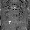 Gravestone commemorating Ninian Morison, d.1725. 'By Hammer in Hand all Arts do Stand'; royal crown, hand holding hammer.
