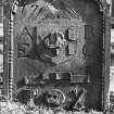 Perth, Greyfriars Burial Ground.
View of the Alexander Bissett stone, 1777. An arch-shaped stone with the tools of a barber, Memento Mori ribbon, hourglass, skull and crossed bones and winged soul.