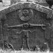 Gravestone commemorating Janet Edward, d.1737. Angels of the resurrection, skeleton with hourglass, winged soul, sexton's tools, deid bell and coffin.