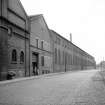 View from W showing SSW front of warehouse (after it became part of forge) with part of forge on right and left