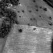 Chapel on Leader, oblique aerial view, taken from the WSW, centred on the cropmarks of an enclosure. Chapel on Leader Country House is visible in the top left-hand corner of the photograph.