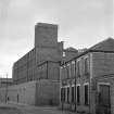 Glasgow, 177 Reid Street, Barrowfield Spinning Factory
View from SW showing part of WNW and SSW fronts of mill with NW block of oil works in foreground