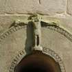 Detail of carved crucifix above doorway on West side of tower.