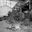 Coatbridge Engine Works, Engineering Shop; Interior
View showing part of number two bay, the eastmost of the three bays, with a brick press being overhauled