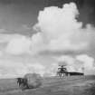 Copy of historic photograph showing 'bedstead' type radar aerial with mast and transmitter/receiver building behind.  A horse and hay-cart is visible in the foreground.